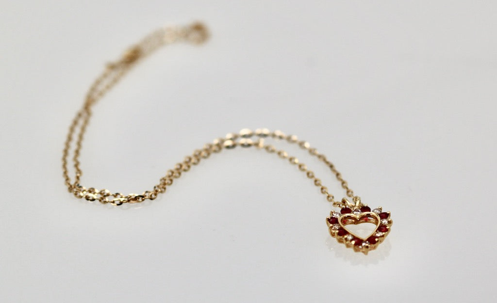 Yellow gold heart pendant with gems