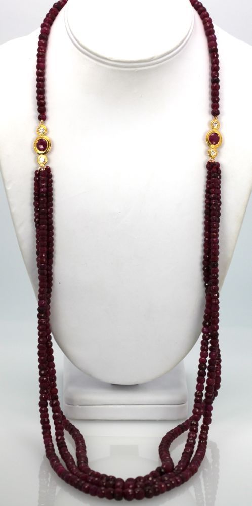 Triple Strand Ruby Bead Necklace with Diamonds – hanging on model