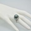 Tahitian South Seas Black Pearl Ring with Diamond surround on finger