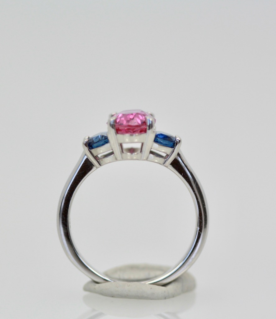 Three-Stone Ring in Pink and Blue Sapphires – bottom on stand