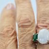 Moonstone 3 stone Ring with Emeralds - close up on finger