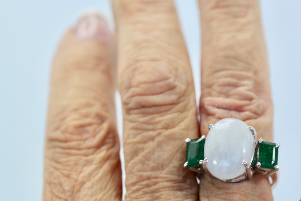 Moonstone 3 stone Ring with Emeralds – close up on finger