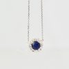 Blue Sapphire Pendant Necklace with Diamond Surround - hanging close up