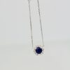 Blue Sapphire Pendant Necklace with Diamond Surround - hanging
