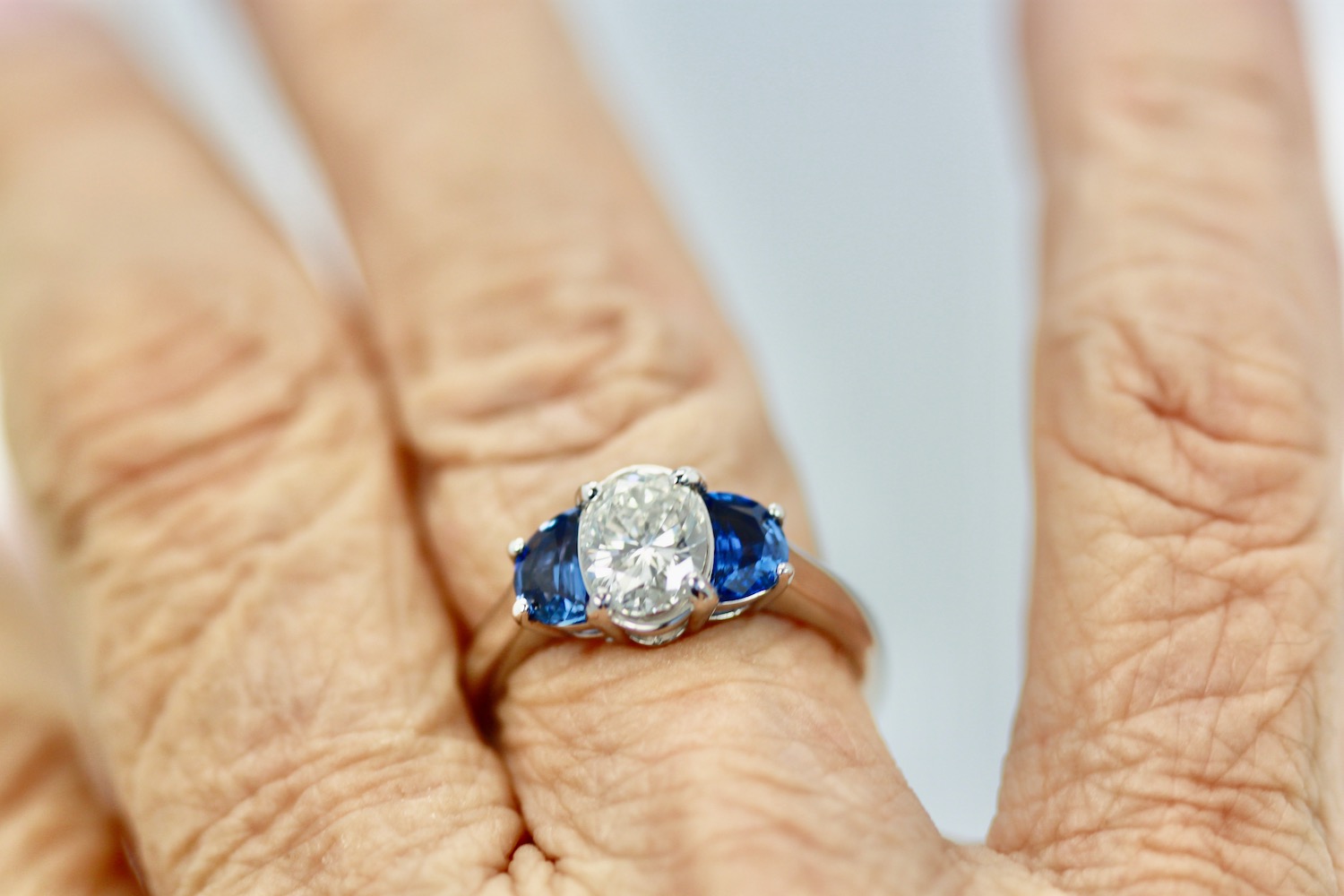 Diamond Ring with Half Moon Sapphire Sides – on finger