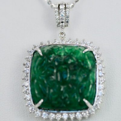 Emerald Carved Pendant set in Diamond surround 18K